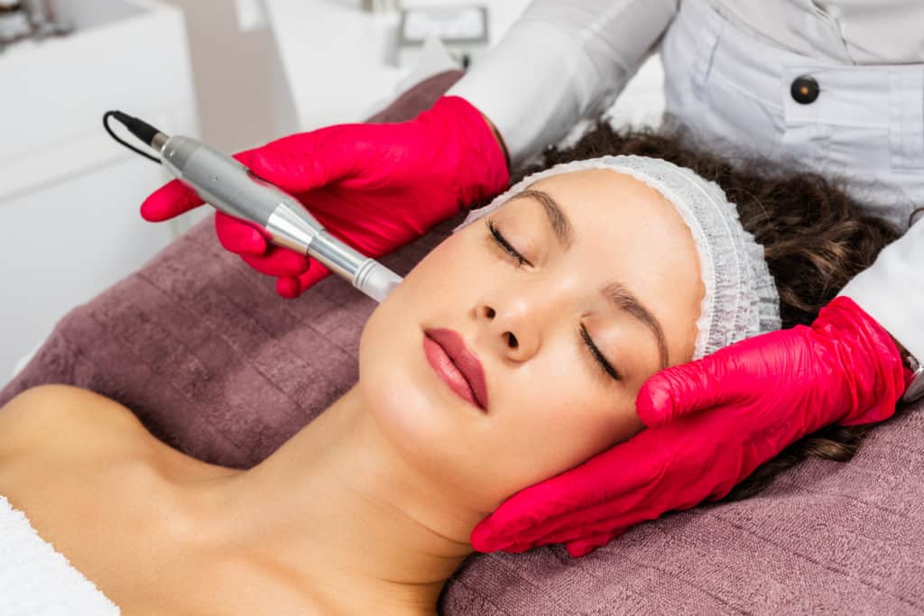 Beautiful woman receiving microneedling treatment at Elysian Beauty & Wellness | Waycross, GA