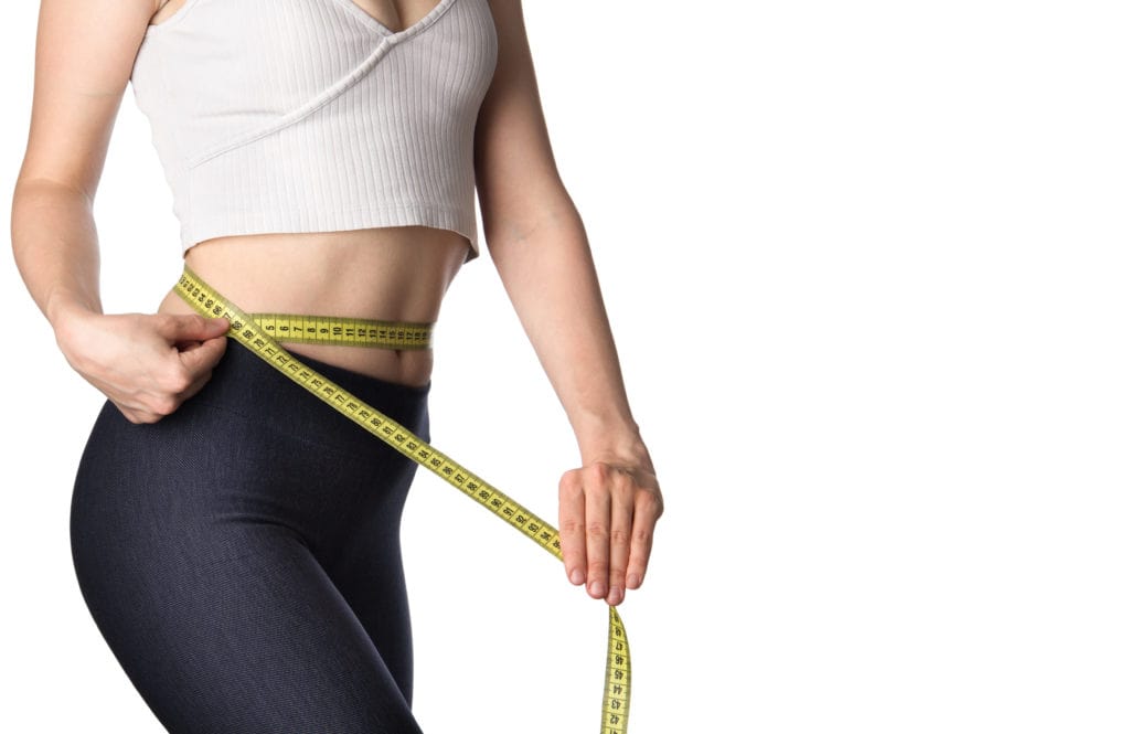 Woman measuring her body | Weight Loss Treatment at Elysian Beauty & Wellness | Waycross, GA